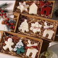 Cajas de regalo con figuras navideñas de árboles, renos, copos y casitas